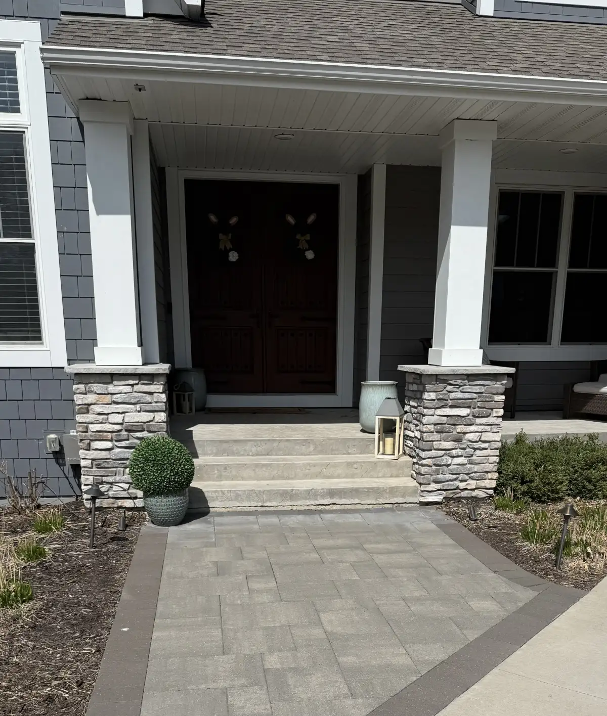 Backyard after renovation with retaining wall and paver patio