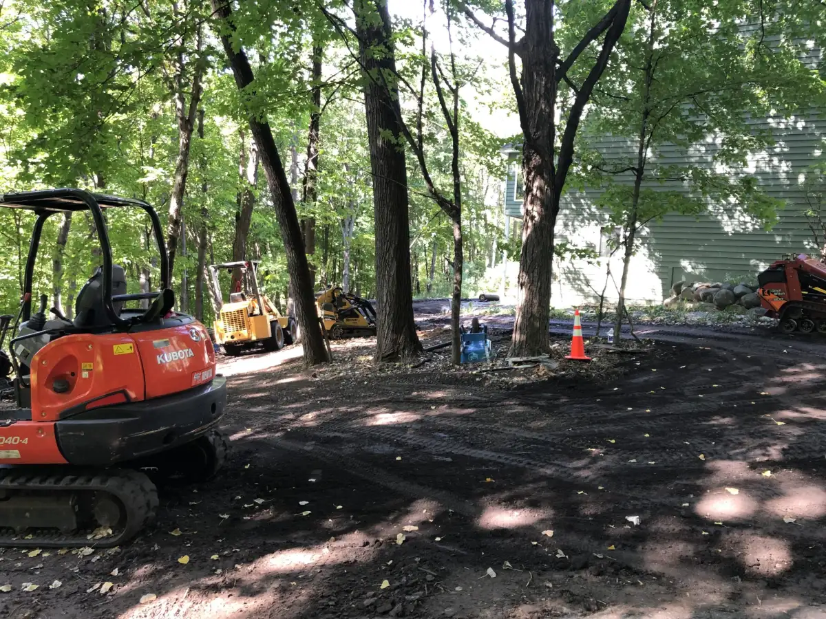 Landscape Charlie crew and equipment on a project site in the Lake Minnetonka area