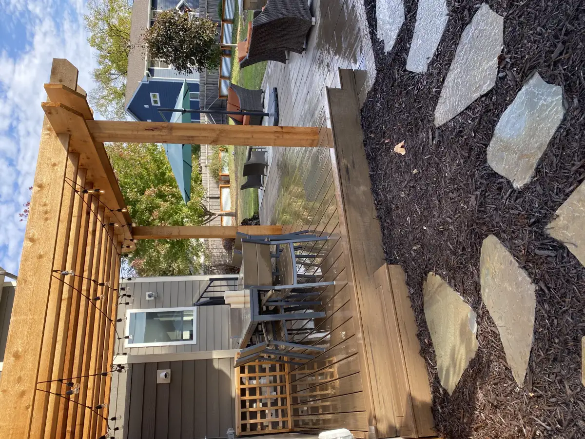 Deck with pergola overhead and outdoor furniture arrangement