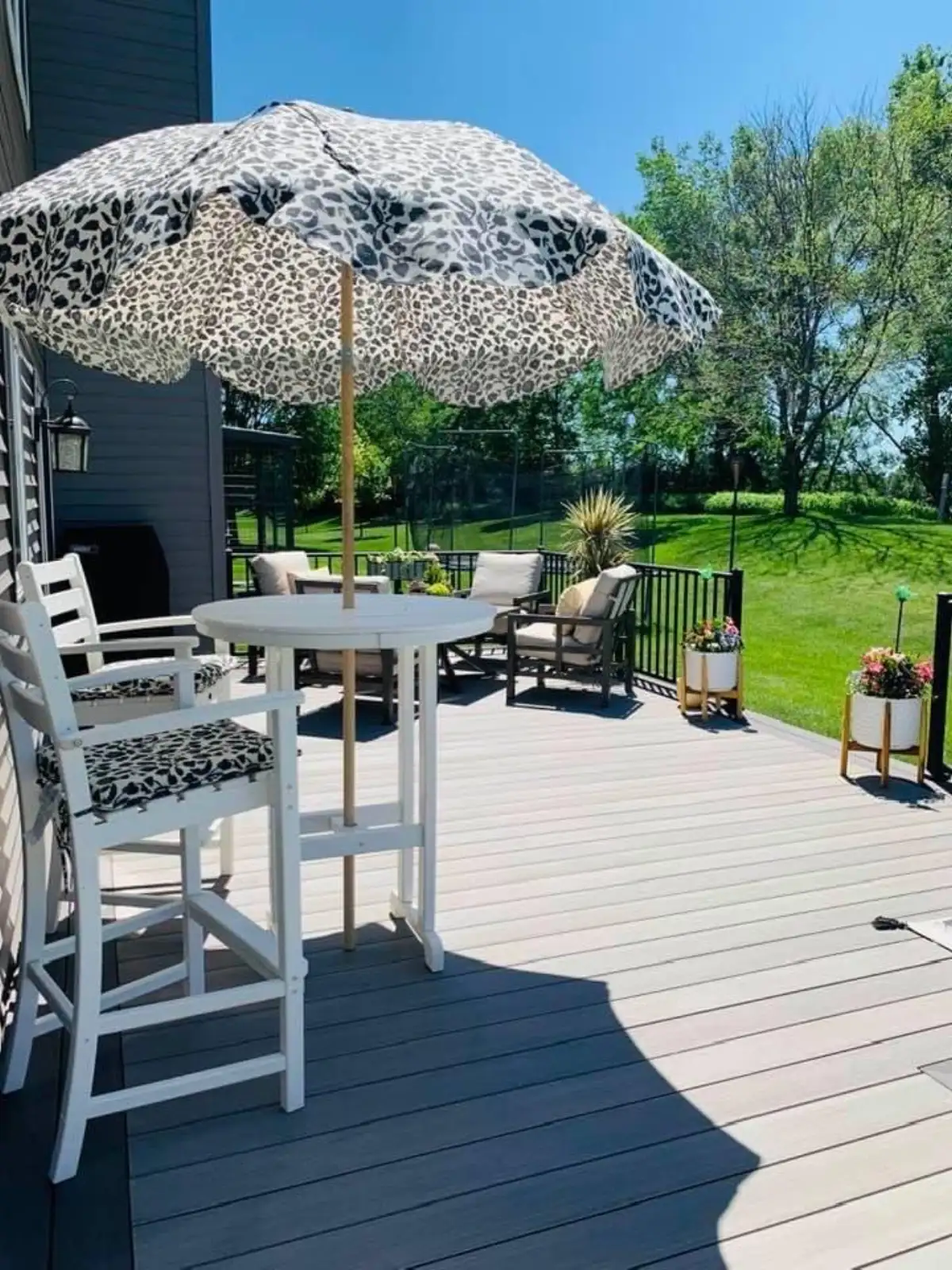 Wrap-around composite deck with mixed railing styles