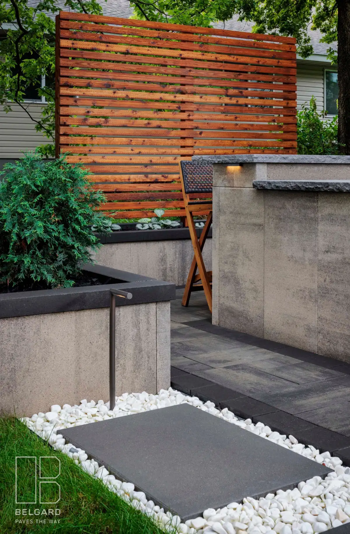 Belgard landscape design with path lighting and white rock garden accents