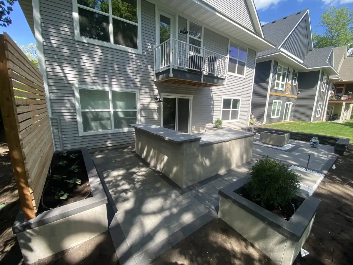 Estate tier complete backyard transformation with outdoor kitchen, fire pit, and planter beds