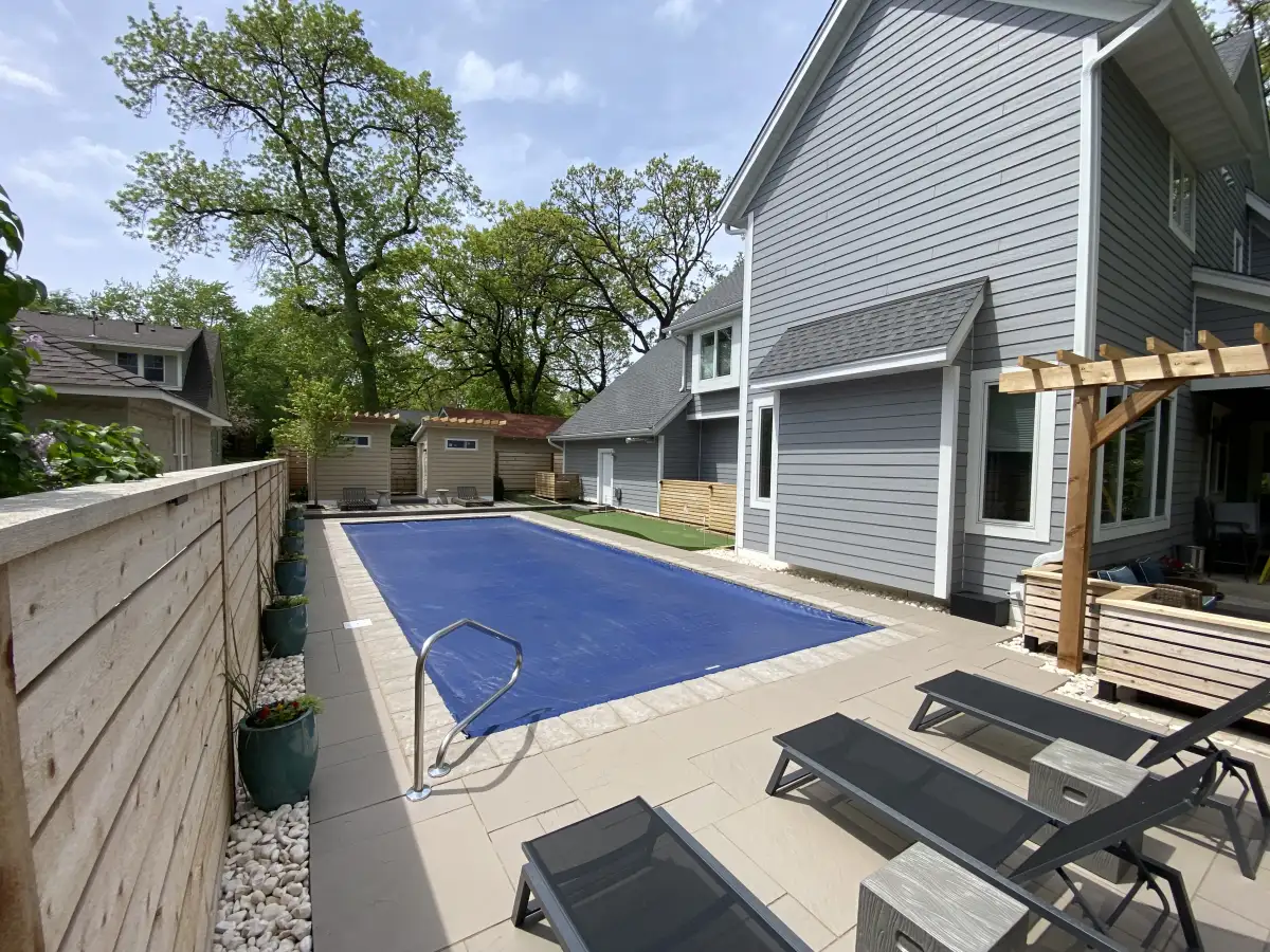 Legacy tier pool surround with paver patio, privacy fencing, and lounge area in Minnesota