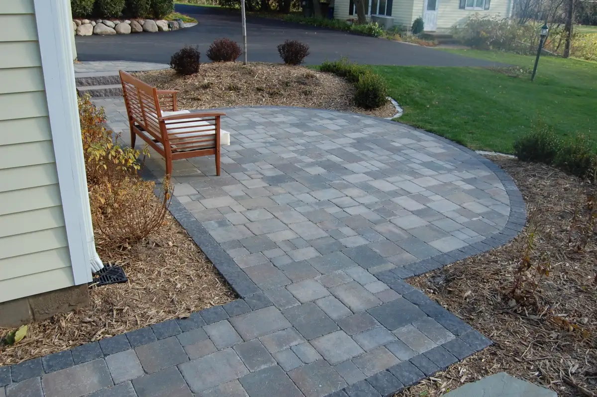 Signature tier paver patio with bench seating and mulch beds — $10-20K landscape enhancement in Minnesota