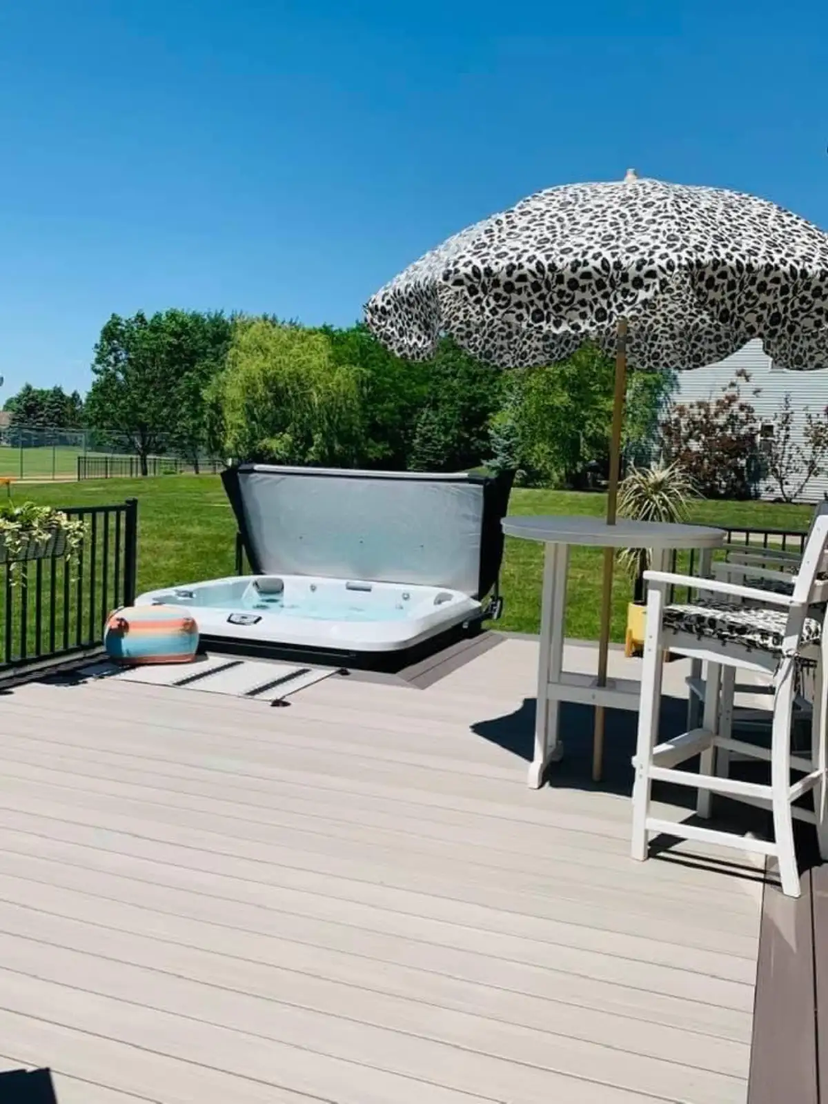 Luxury outdoor room with pergola and landscape lighting at dusk