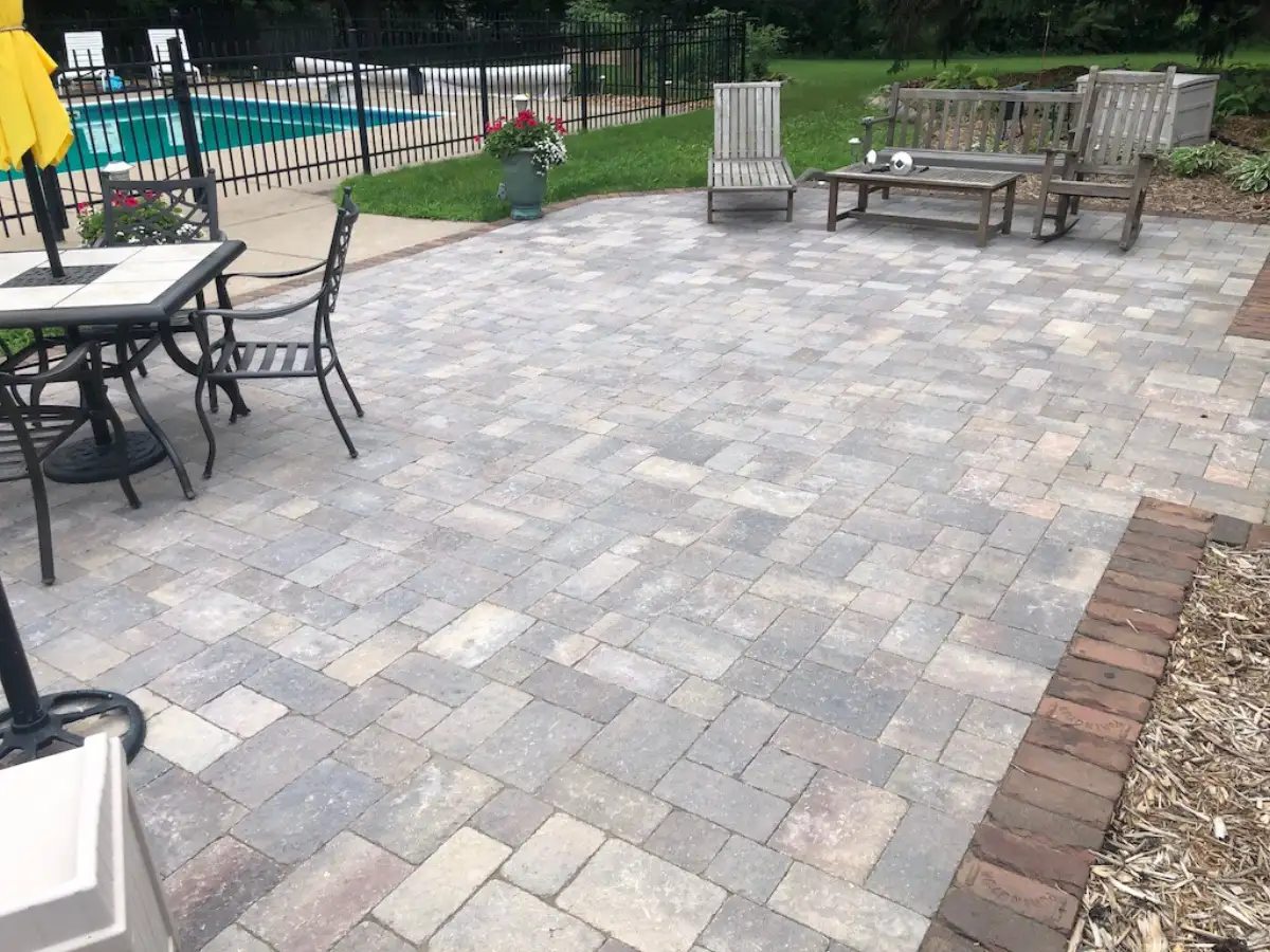 Curved paver patio with natural stone accents