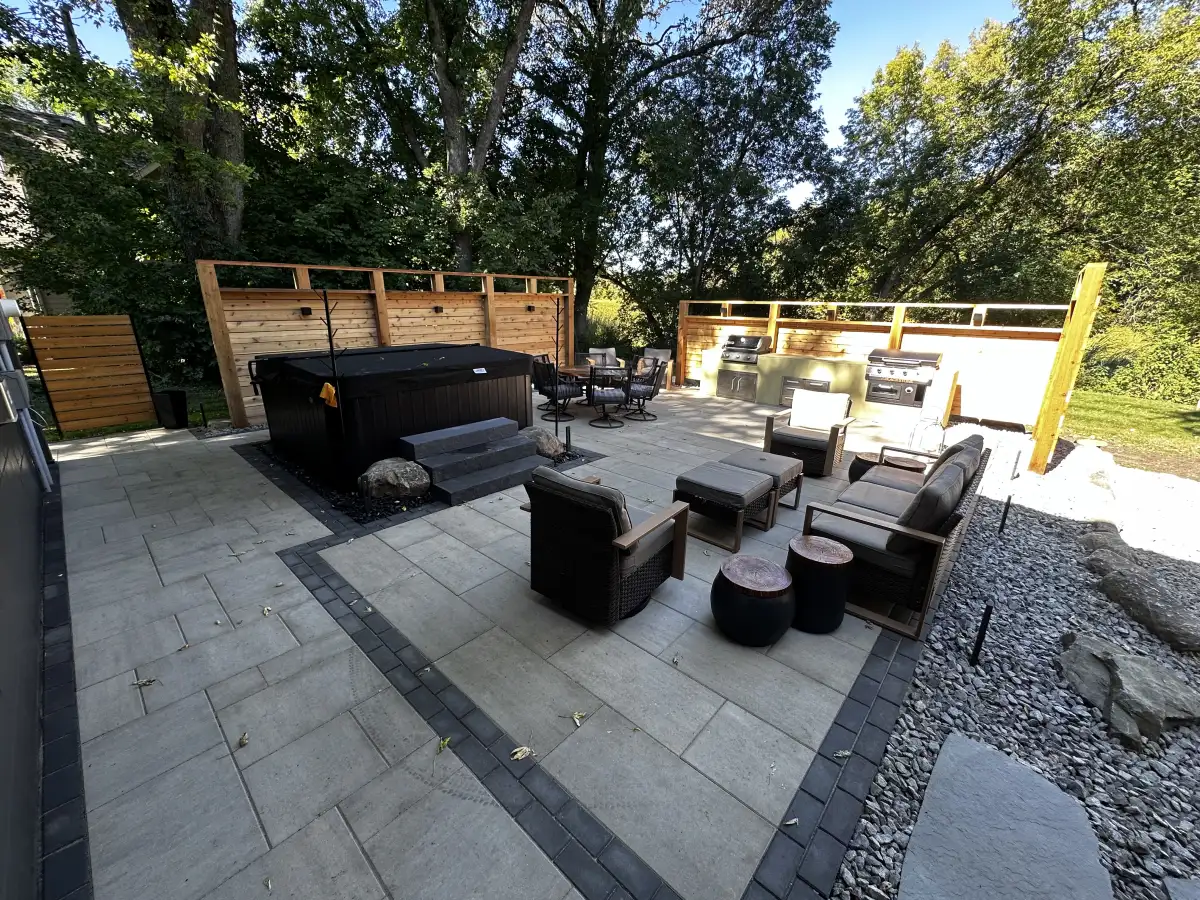 Multi-level paver patio with natural stone accents and steps