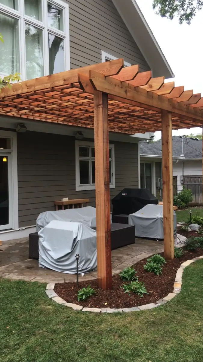 Pergola with stone columns and overhead lattice detail