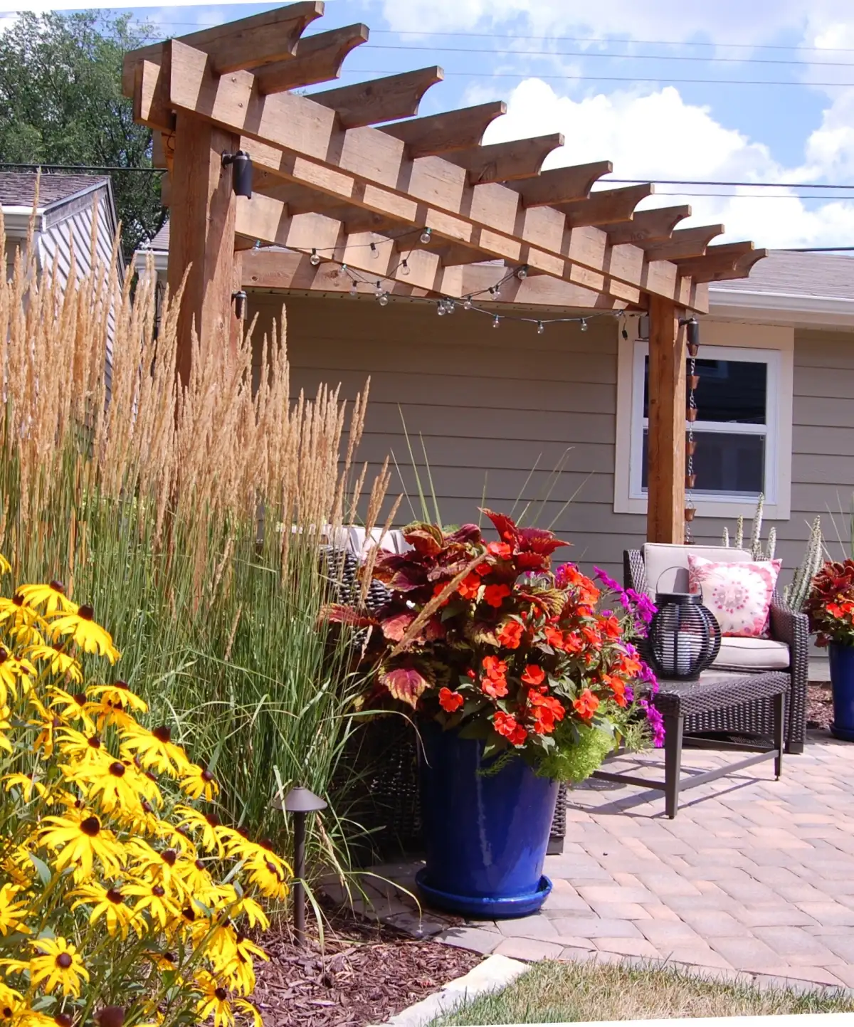 Custom cedar pergola with outdoor curtains over patio