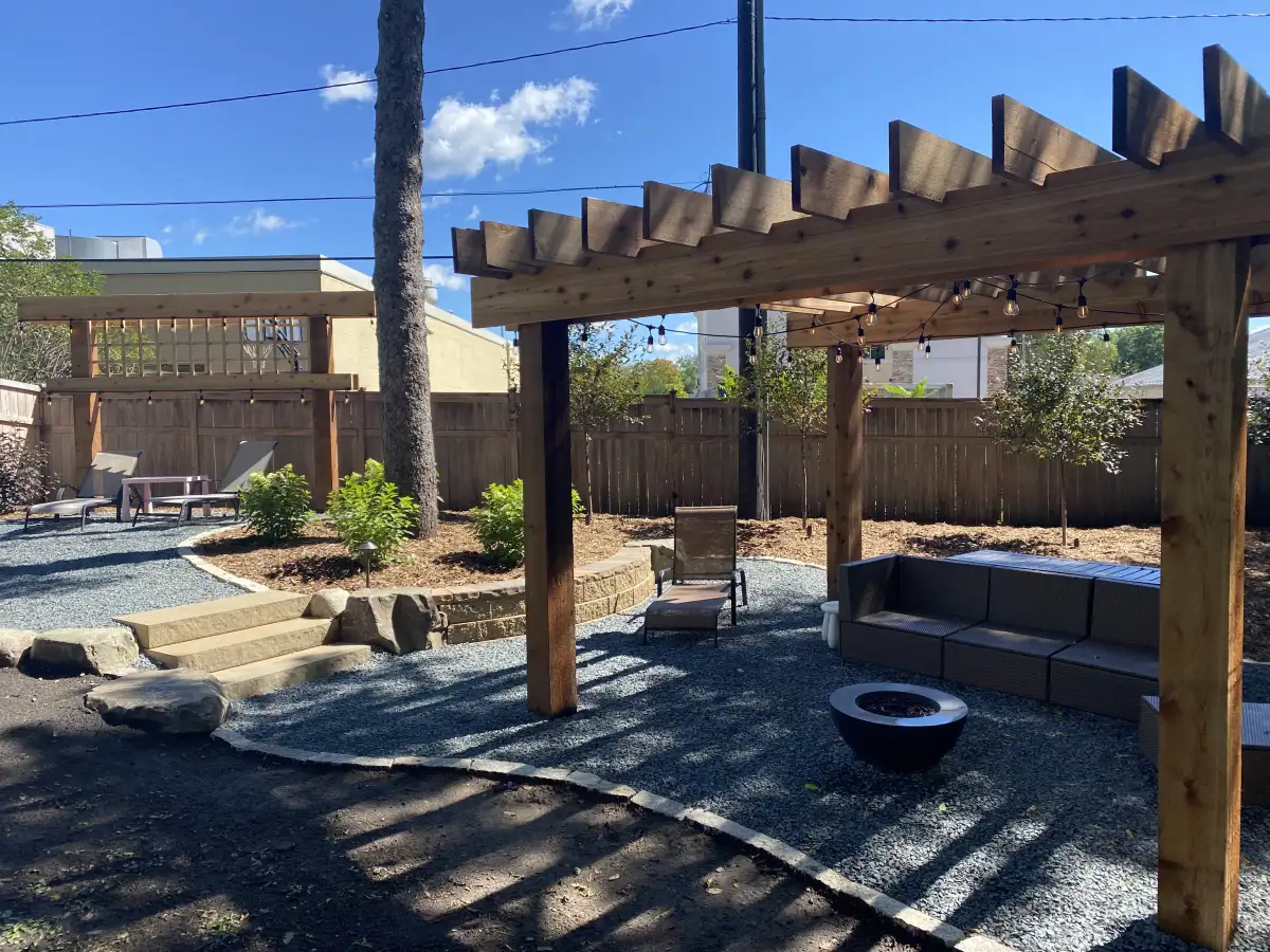 Wood pergola shading a backyard seating area