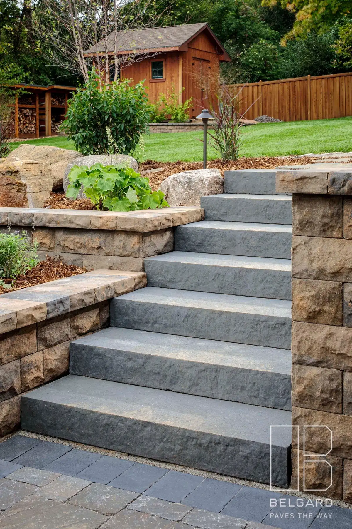Natural stone slab steps with boulder accents along walkway