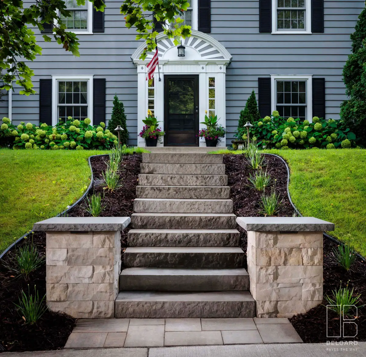 Paver steps with natural stone treads connecting patio levels