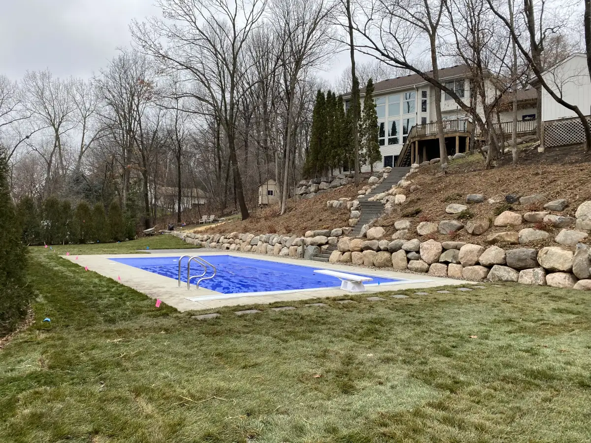 Large-scale boulder retaining wall with native plantings