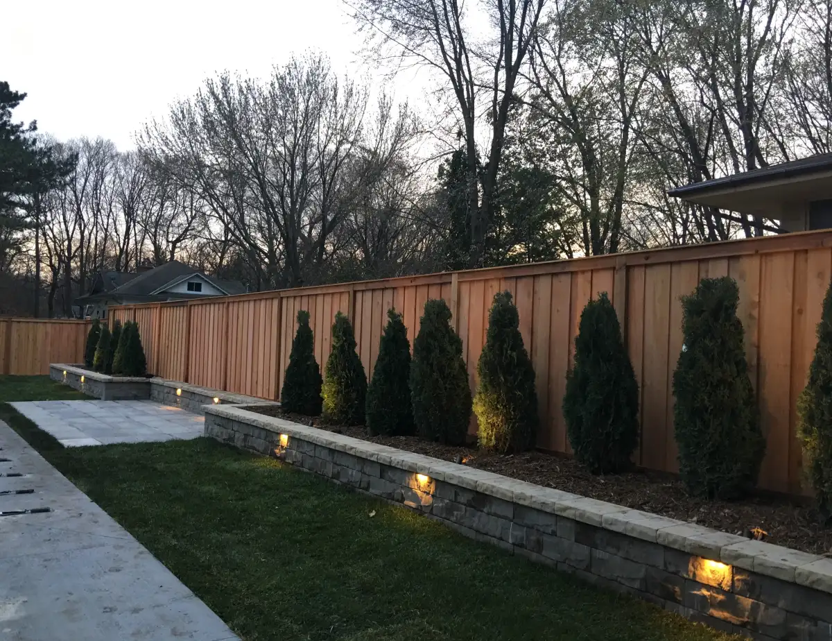 Decorative retaining wall with cap stones and accent lighting